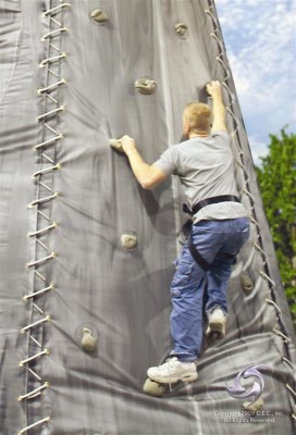 Climber on Tiki Island inflatable climbing wall